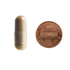 Size comparison of a Libido Lift vegetarian capsule next to a penny to show easy-to-swallow 500mg capsule size.